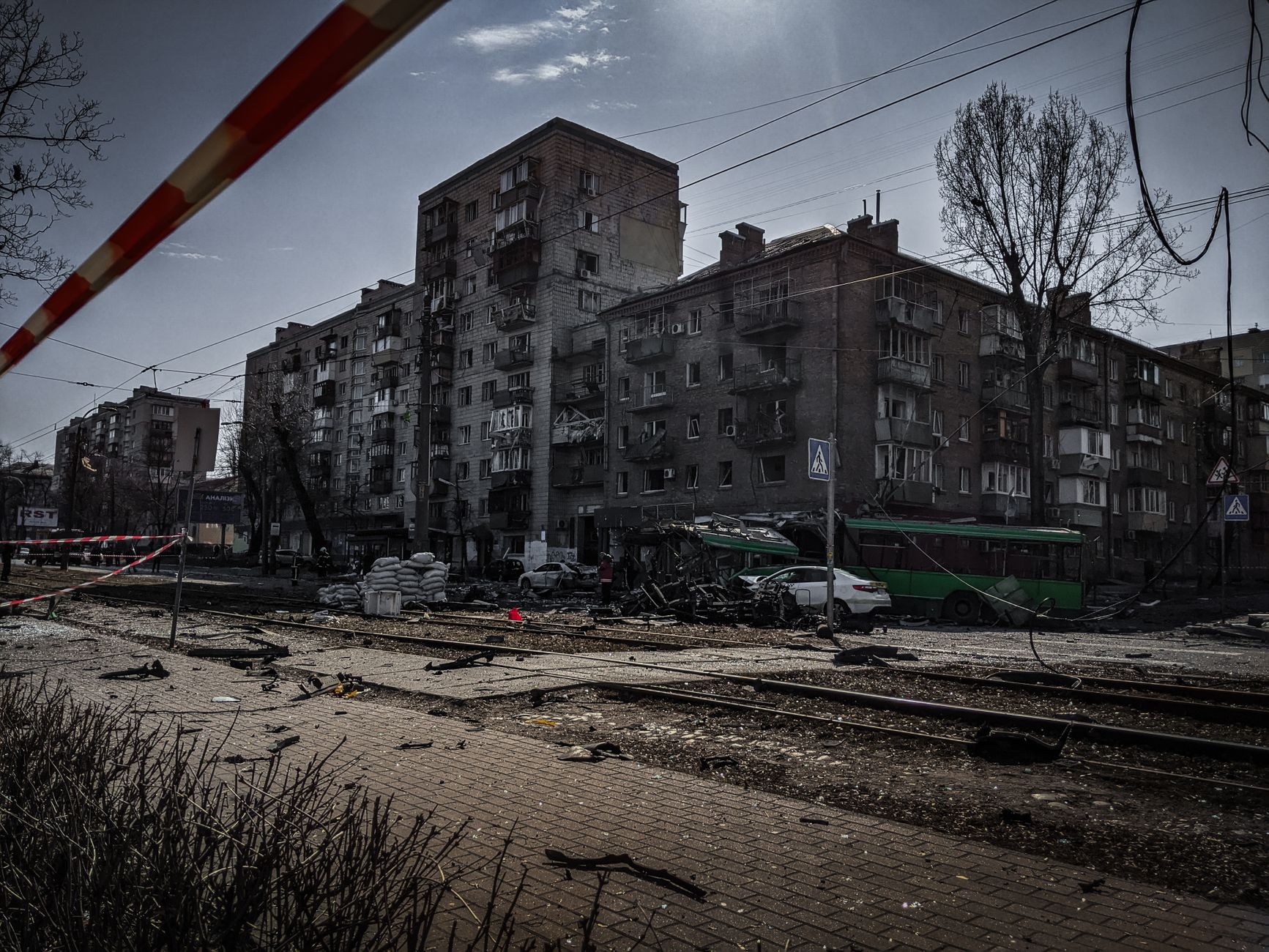 Dramatic urban scene depicting the aftermath of conflict in Kyiv, Ukraine, featuring damaged buildings and debris.