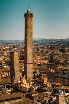 Aerial view of the historic towers in Bologna, Italy, with a vibrant cityscape.