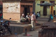 Candid street photography of men conversing at Kathmandu Durbar Square, Nepal.