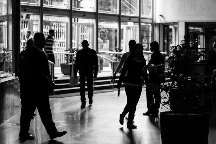 Grayscale Photo Of People In Building