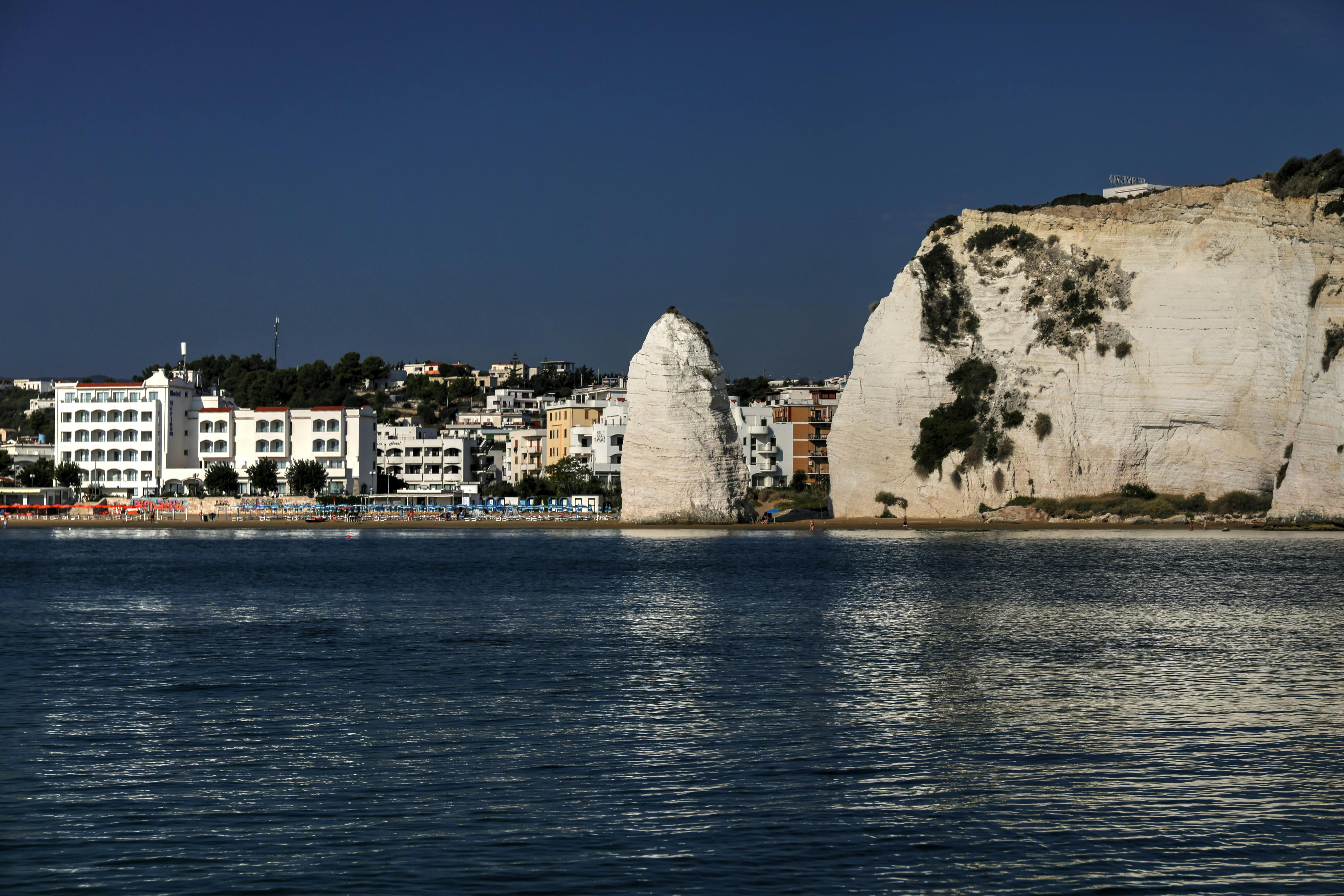 Stunning view of Vieste's cliffs and coastal town, ideal for travel and tourism imagery.
