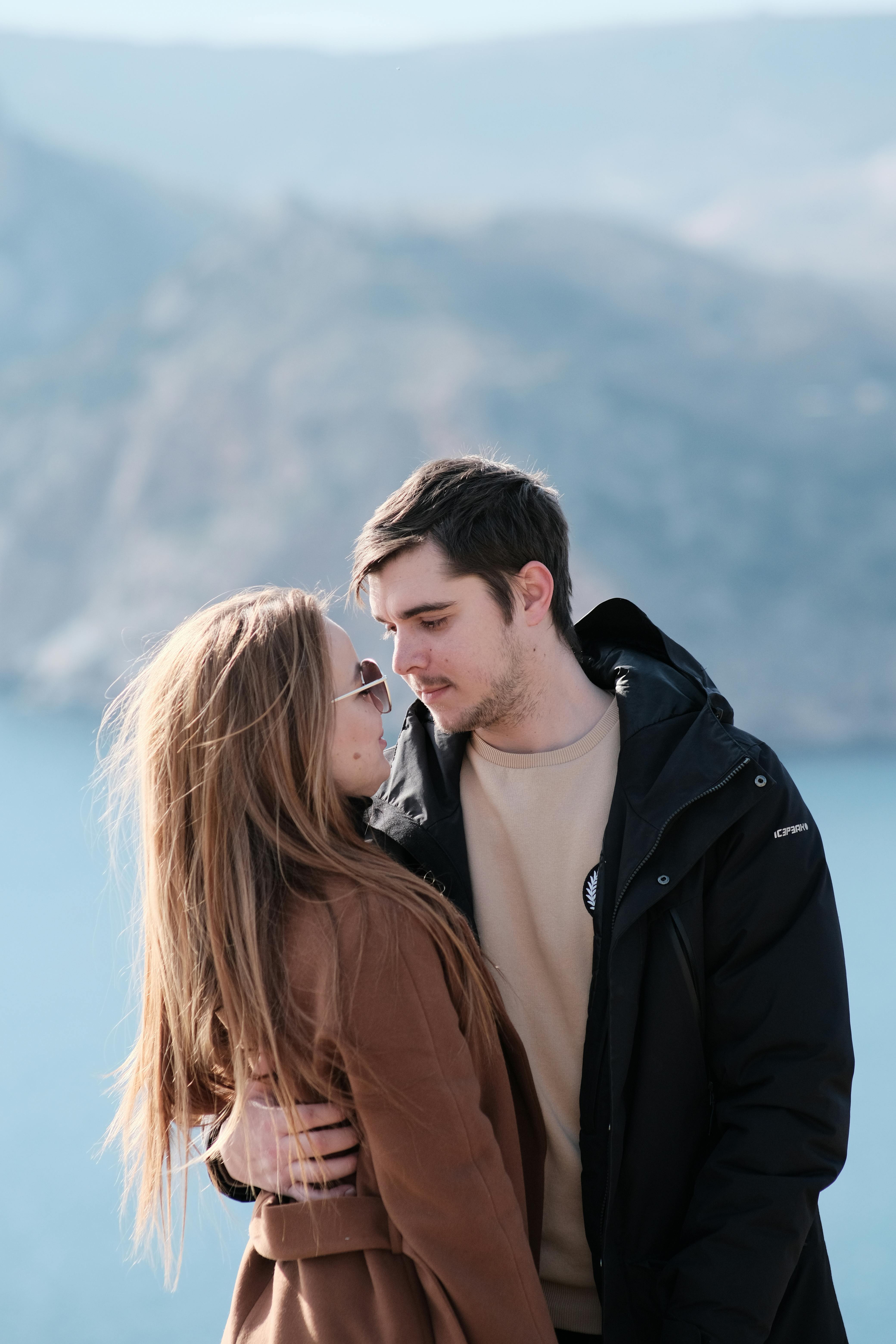 Young Man Embracing His Girlfriend and Looking in Her Eyes · Free Stock Photo