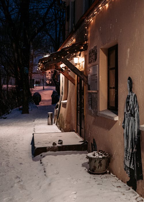 Brown Concrete House with Illuminated String Lights at Night Time