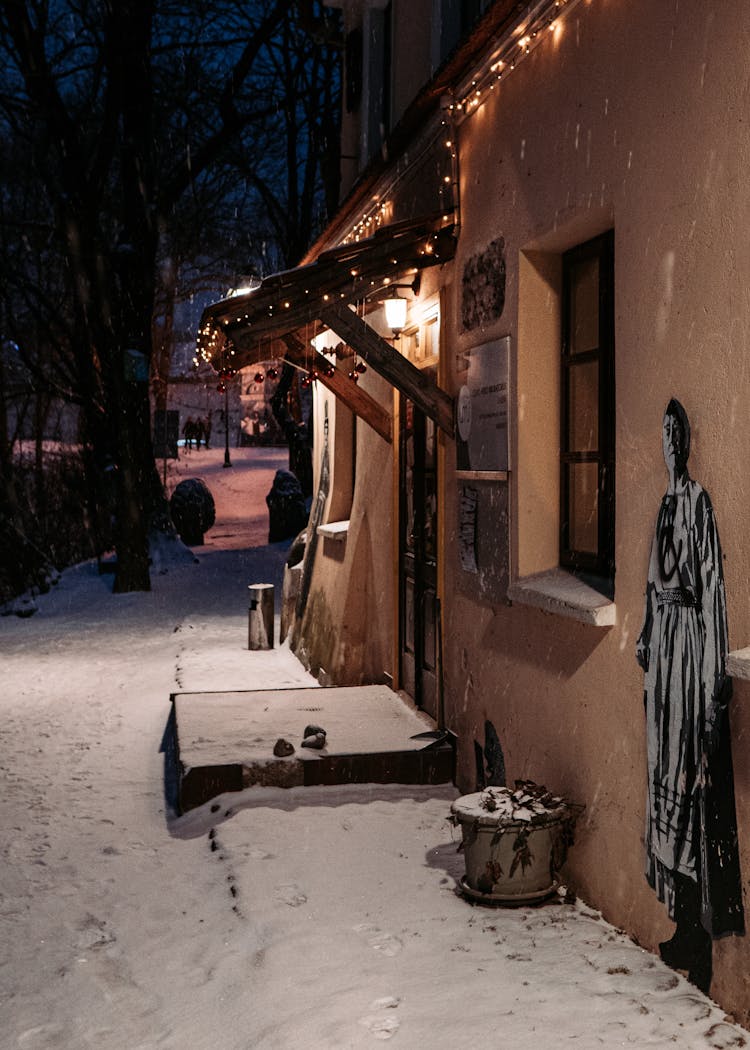 Brown Concrete House With Illuminated String Lights At Night Time