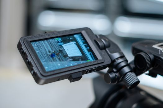 Close-up view of a camera monitor displaying captured footage with detailed settings.
