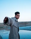 Man in Gray Hoodie Standing on Beach