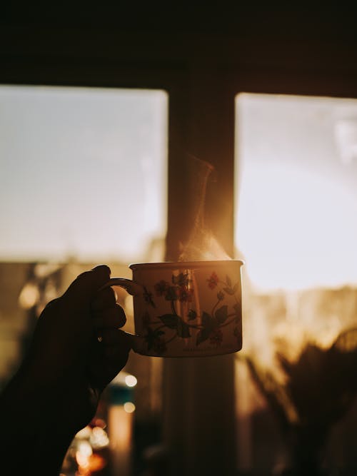 Free Person Holding Steaming Mug of Coffee Stock Photo