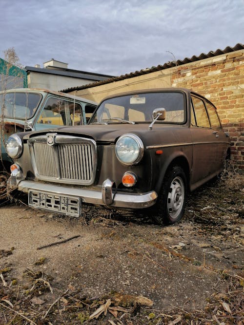 Dirty Vintage Car by a Brick Wall