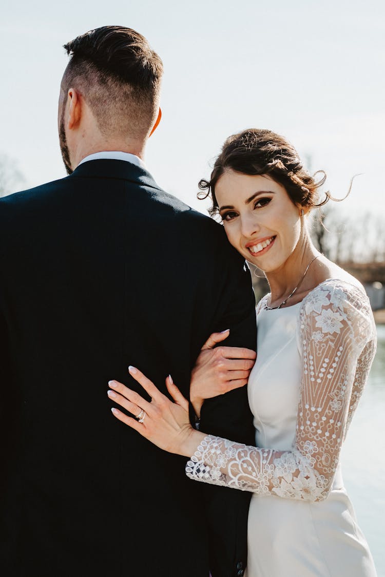 Wedding Portrait Of Bride Holding Groom's Arm