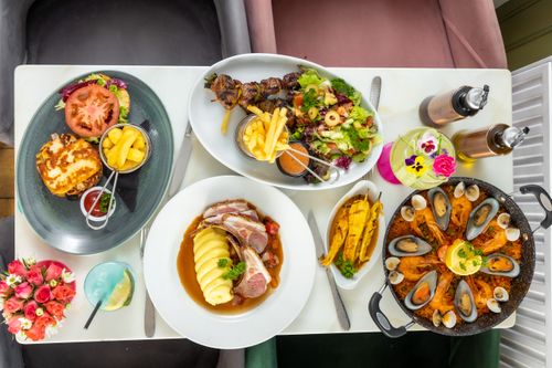 Free A variety of delicious dishes presented on a white table, capturing an upscale dining experience. Stock Photo