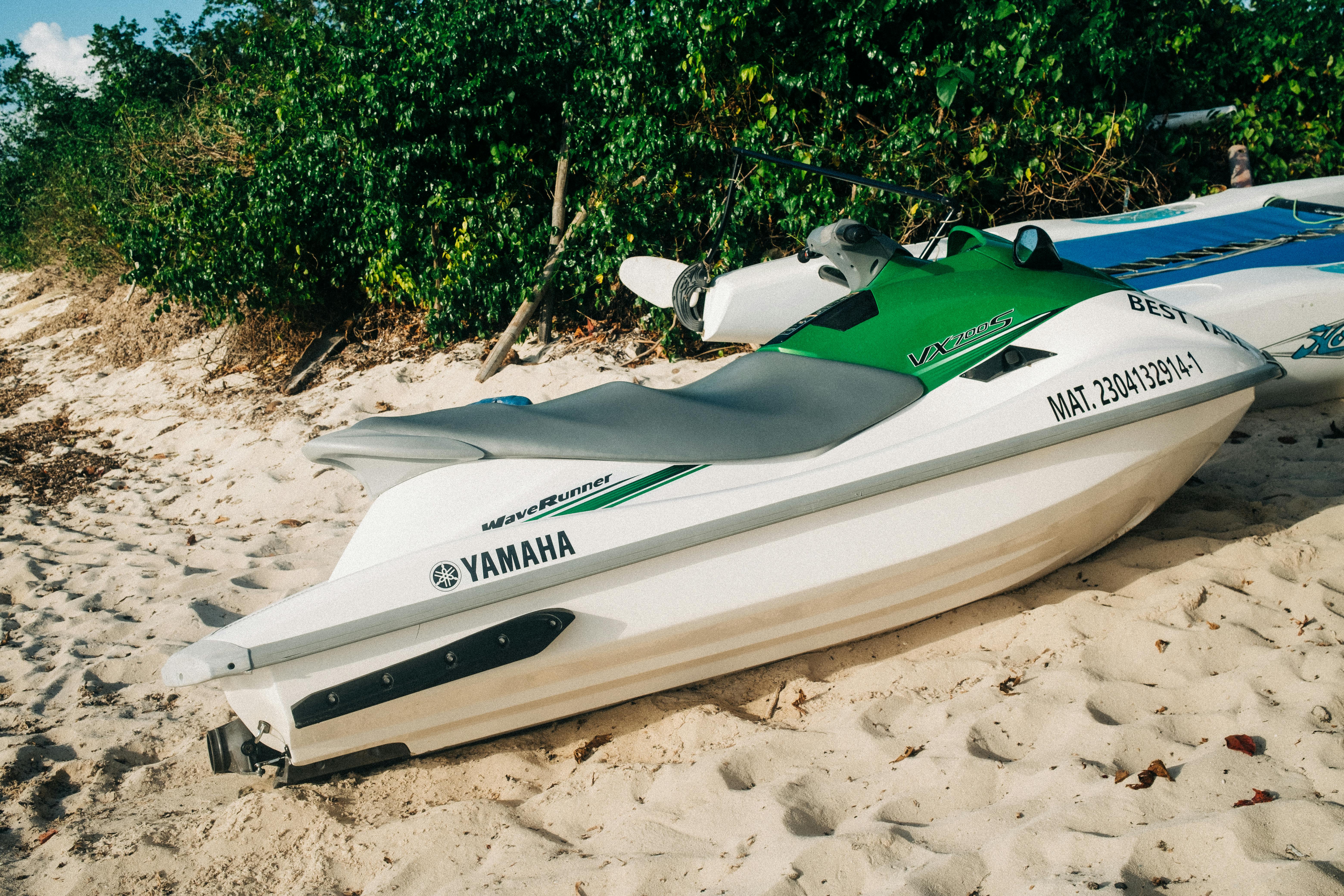 Prescription Goggle Inserts - Jet skis parked on a sandy beach with lush tropical greenery in the background.