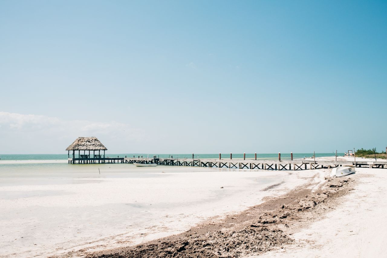 Deserted beach of Isla Holbox at sunset