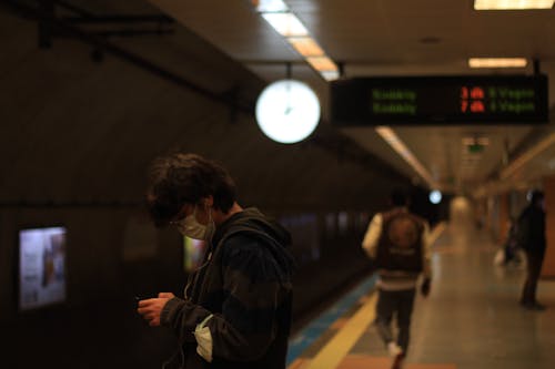 Photograph of a Person Waiting at a Subway Station