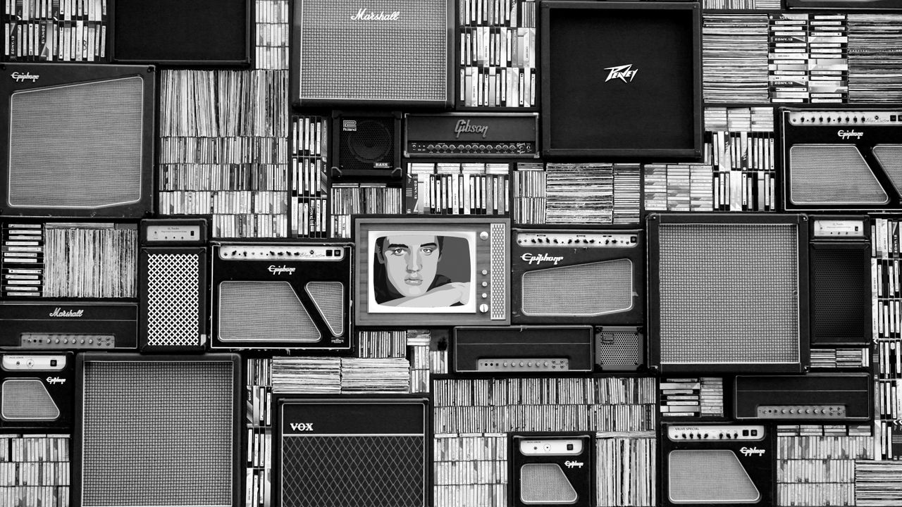 vintage amplifiers and vinyl records arranged in a striking black and