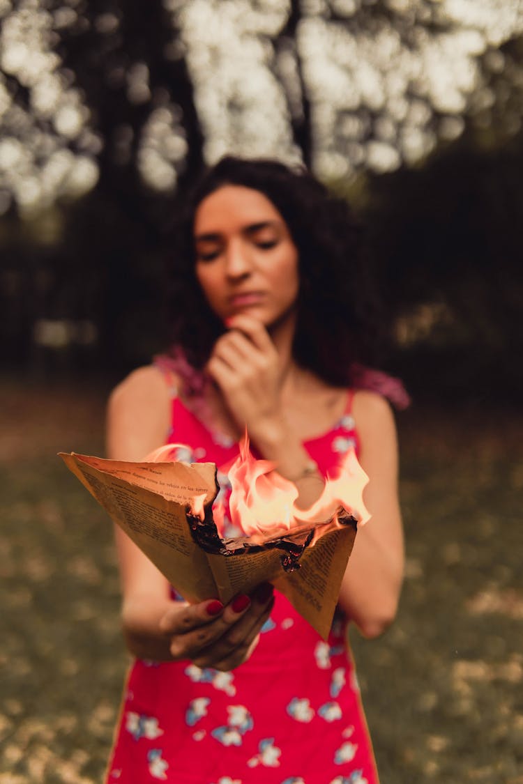 Woman Burning A Paper