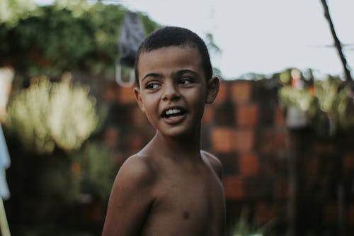 Close Up Photo of a Shirtless Boy