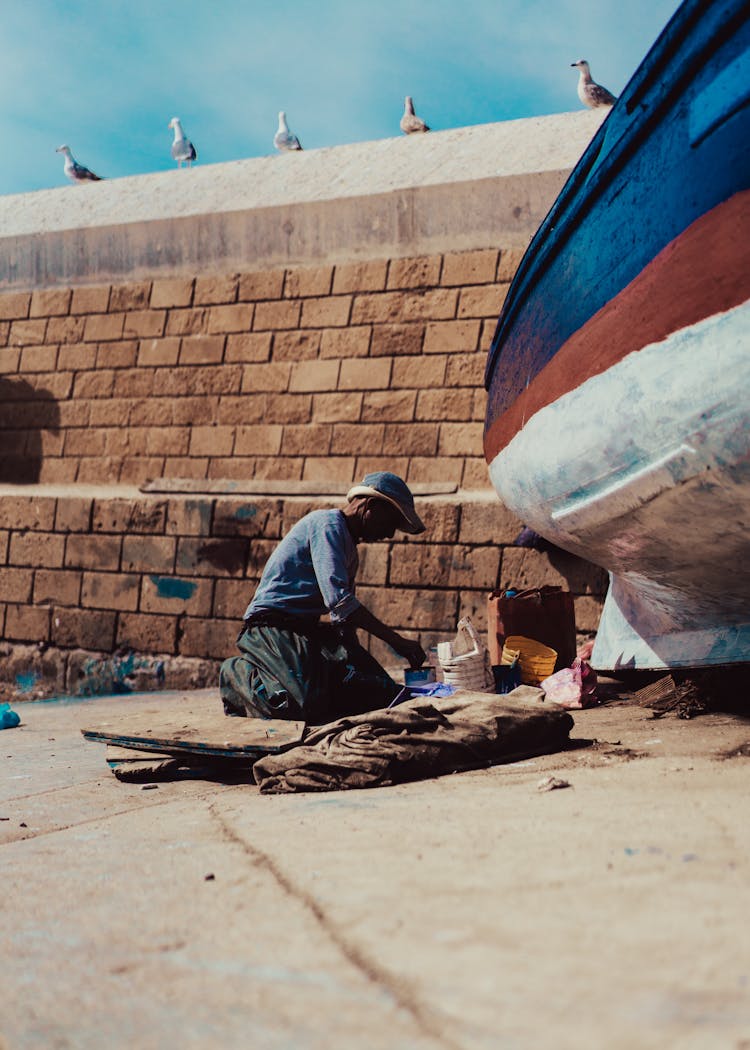 Man Painting A Boat