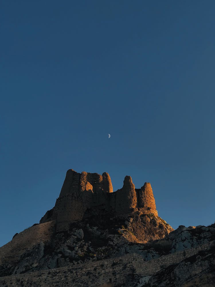 Crescent Moon Over Rock Formation