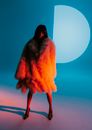 Woman Wrapped in Fur Coat and High Heels Lit by Red Light 