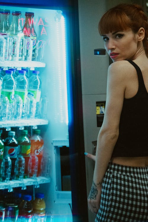 A Woman Standing in Front of Vending Machine