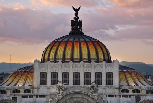 Free The majestic dome of Palacio de Bellas Artes in Mexico City at sunset with vibrant sky. Stock Photo
