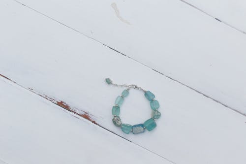 Beaded Bracelet on White Wooden Surface