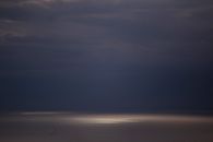 Moody ocean view with dramatic dark clouds and a threatening stormy horizon.