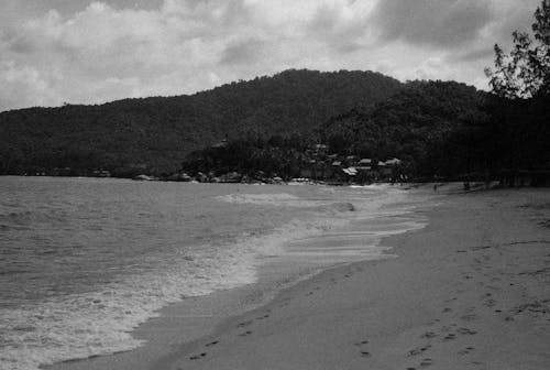 Free Monochrome Photo of a Beach with Footprints Stock Photo