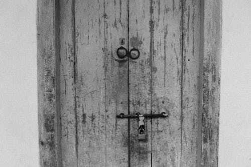 Monochrome Photo of a Wooden Door with a Padlock