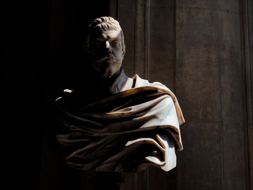 Elegant marble bust with dramatic light and shadow play at Versailles, France.