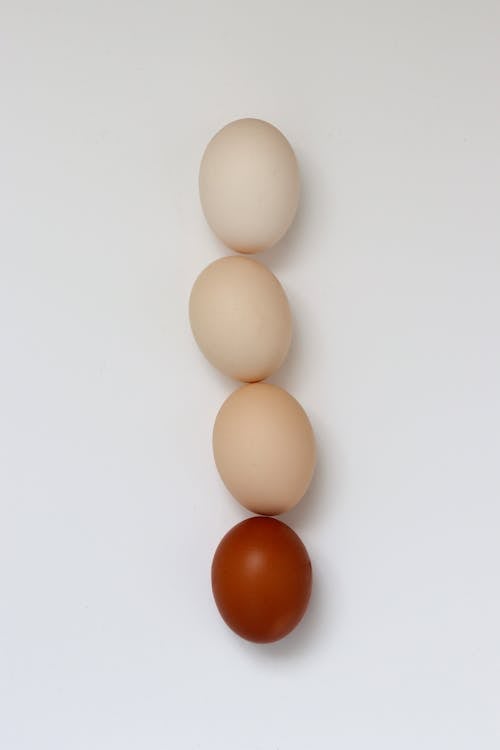 Brown and Red Eggs on White Surface