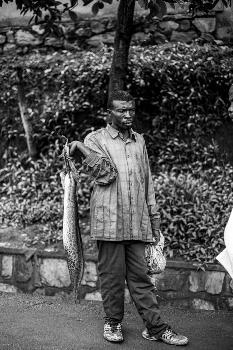 Man In Shirt Holding Fish