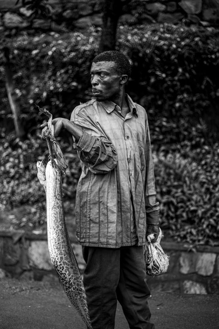 Man In Plaid Shirt Holding Fish