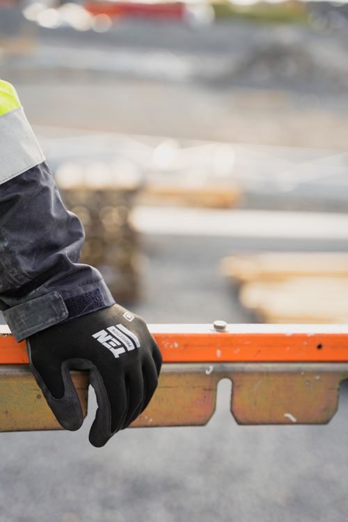 Free Close-up of a construction worker's gloved hand on a safety rail in Borlänge. Stock Photo