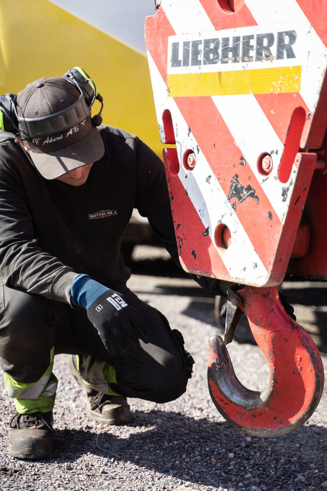 Technician inspecting a crane hook block