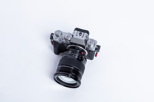Free Overhead view of a DSLR camera with a large zoom lens on a white background. Stock Photo
