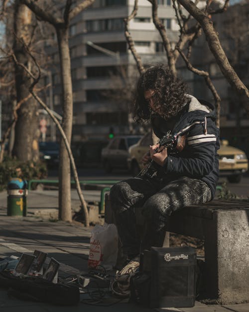A Man Playing Guitar on the Street