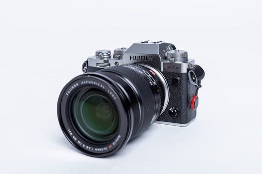 A Fujifilm X-T4 mirrorless camera with a zoom lens on a white background.