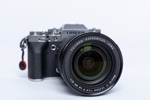 Detailed view of a modern digital camera featuring a Fujinon lens, perfect for photography enthusiasts.