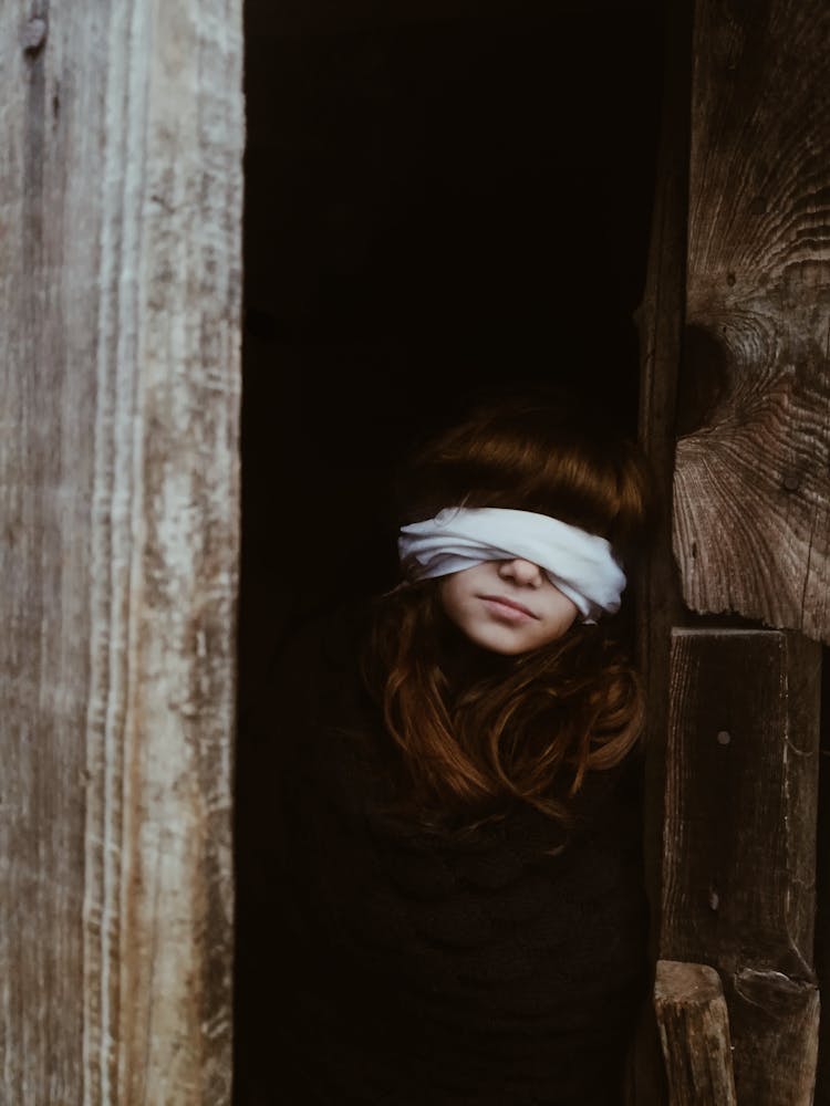 Blindfolded Teenage Girl In Ajar Door 