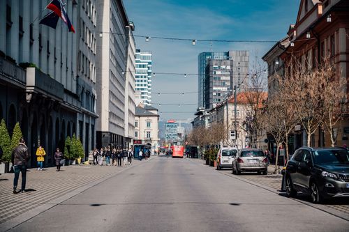 Free A bustling street in Ljubljana, Slovenia with people, cars, and picturesque buildings. Stock Photo