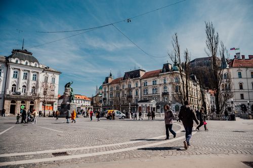 Free People enjoying a sunny day at Prešeren Square, Ljubljana. Historic architecture and vibrant urban life. Stock Photo