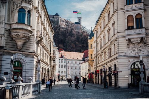 Free Stroll through a historic street in Ljubljana, Slovenia, with a view of the castle atop the hill. Stock Photo