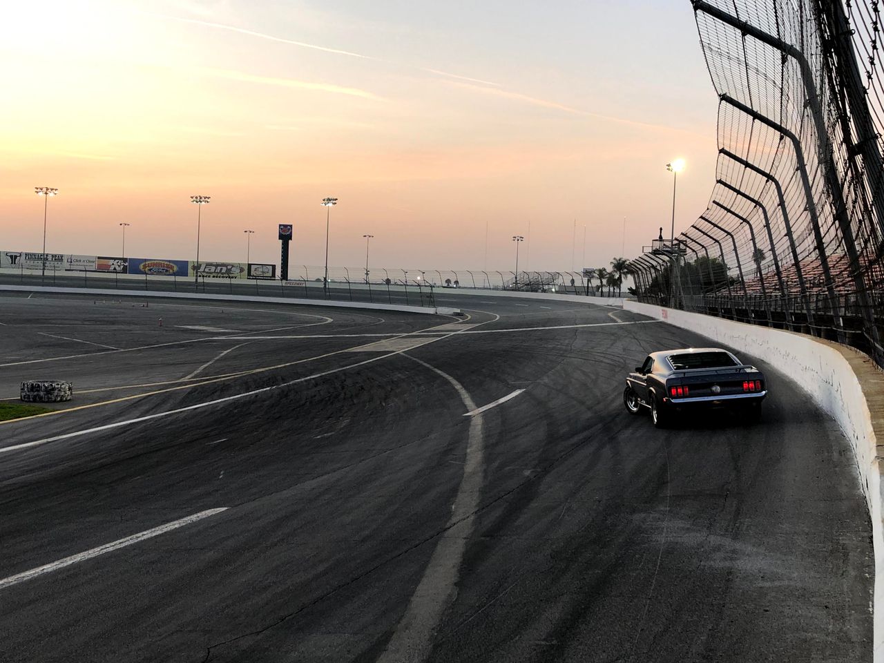 Race car on street circuit at dusk