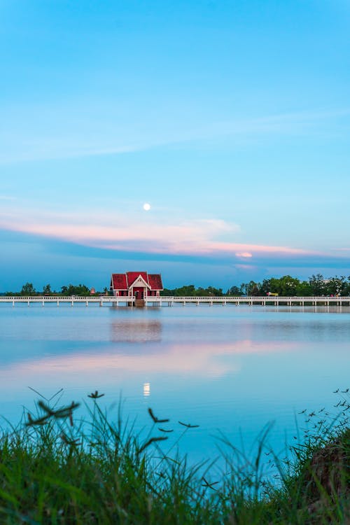 Free House by the Lake at Sunset  Stock Photo