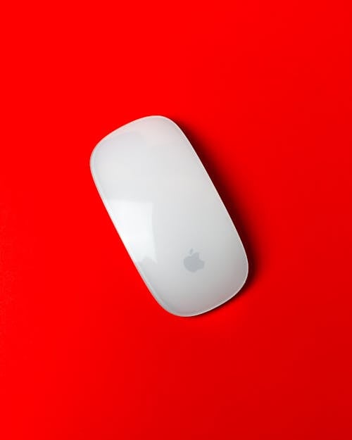 A Magic Mouse on a Red Surface