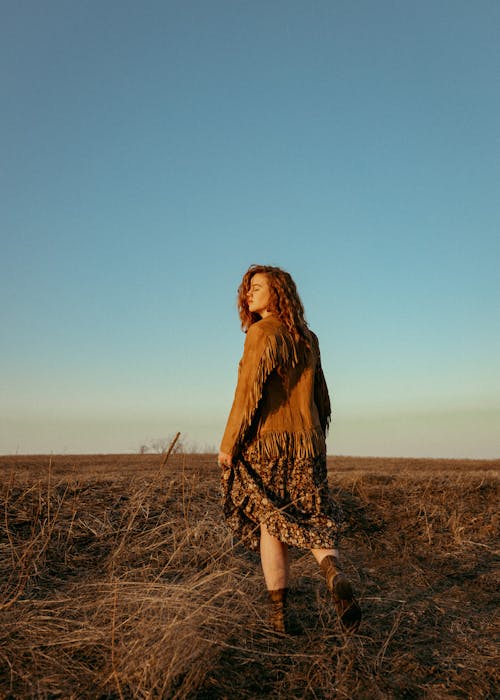 Back View of Redhead Girl Standing in Fields