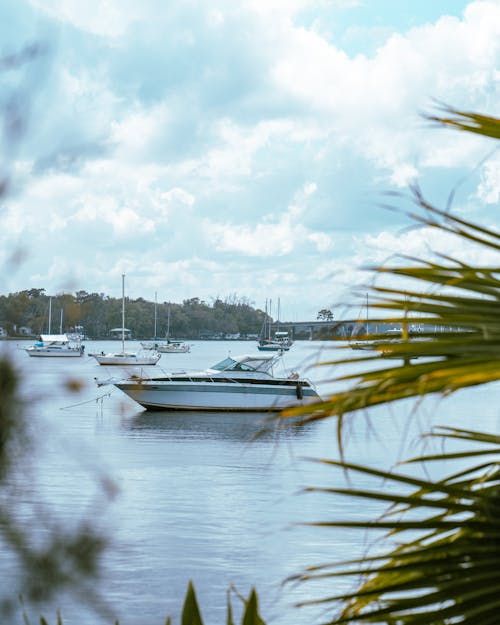 White Boat on Water Under Cloudy Sky