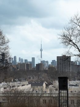 A scenic view of Toronto's skyline featuring the iconic CN Tower under a cloudy sky.