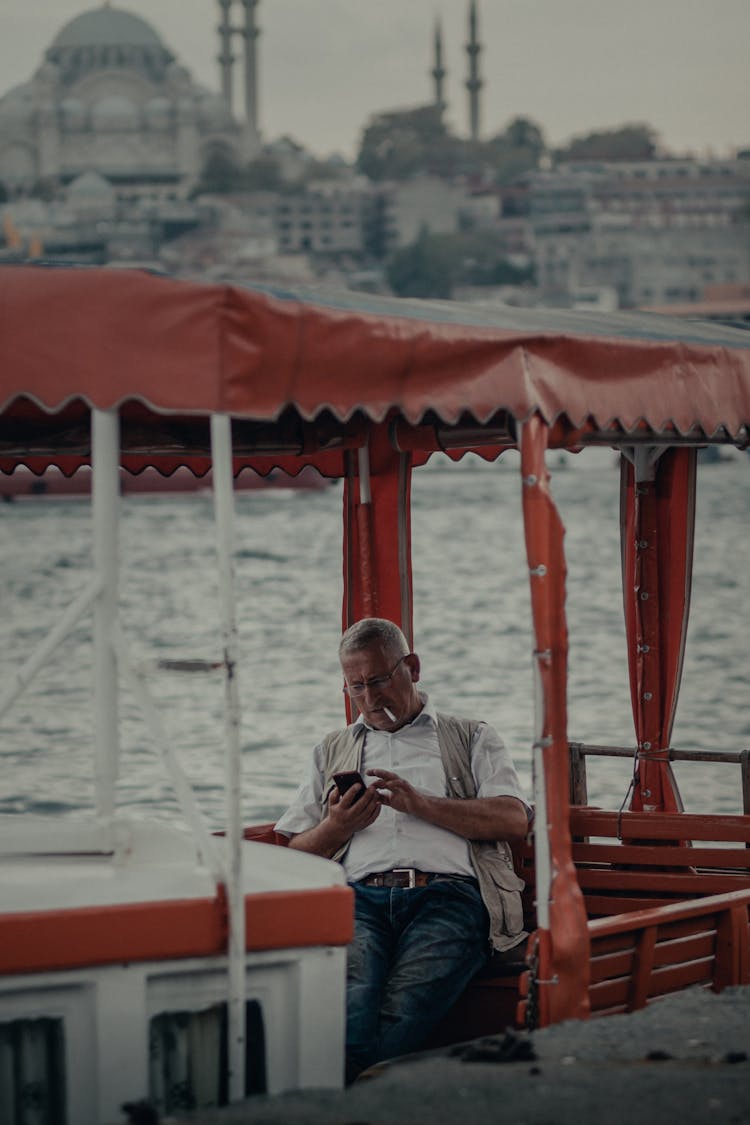 Man On A Boat Using Smartphone